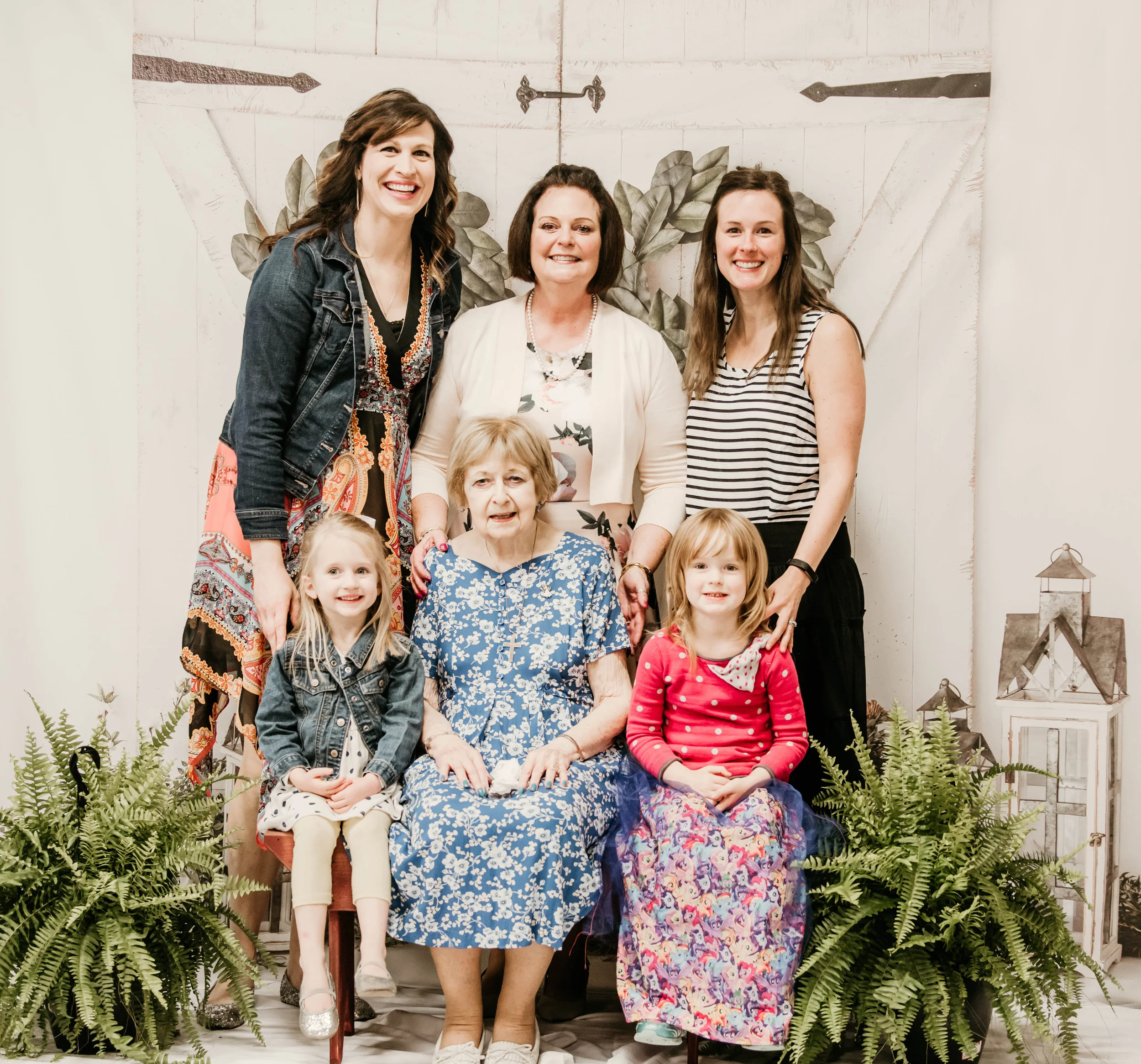 The setup I had for the event. Linda with her mom, daughter-in-laws, and granddaughters. Thank you Linda for adding the ferns and providing the bench and white sheets.