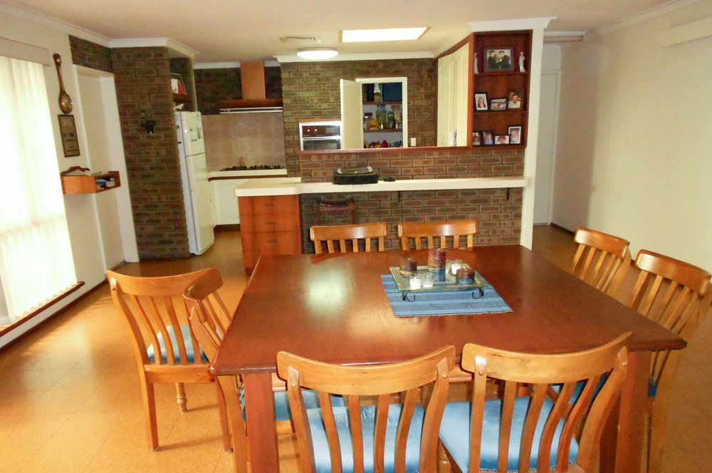Lesley & Peter Before - Problems 1. Exposed red brick around kitchen closed off the kitchen. Wall on the left closing off the hallway into the kitchen. 2. Walk-in pantry is an ineffective storage solution in this before kitchen that takes up a lot of the space. 3. Cooktop location is stuck in the corner and is frustrating to use with no work bench space on each side. 4. Current fridge recess is too small for new double door fridge.