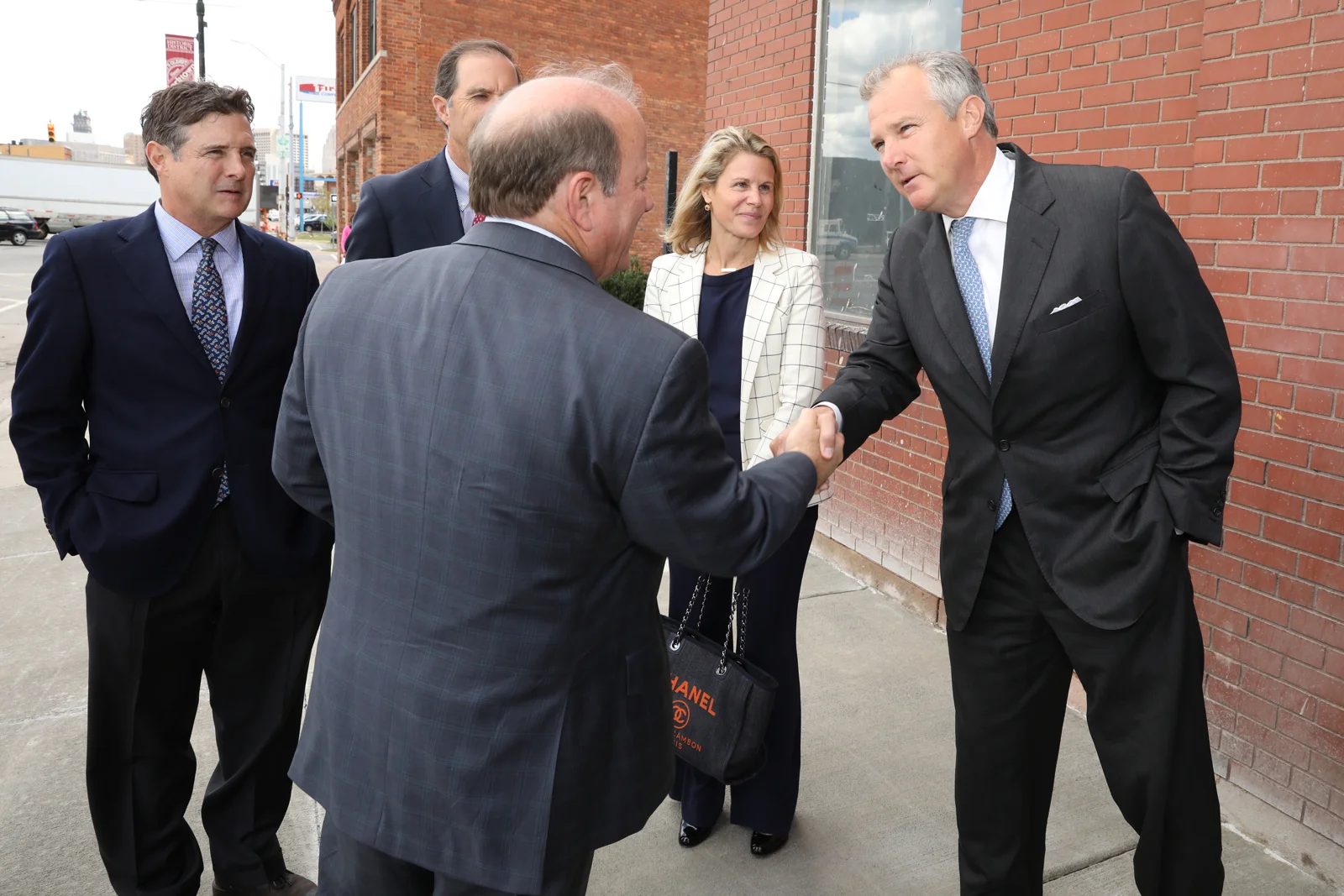 Tom shaking hands with Mayor Mike Duggan at the ribbon cutting of The Factory at Corktown in September, 2017. Also pictured with Tom (left to right) is brother Robbie, partner Britt Greene, and wife Lindsey.