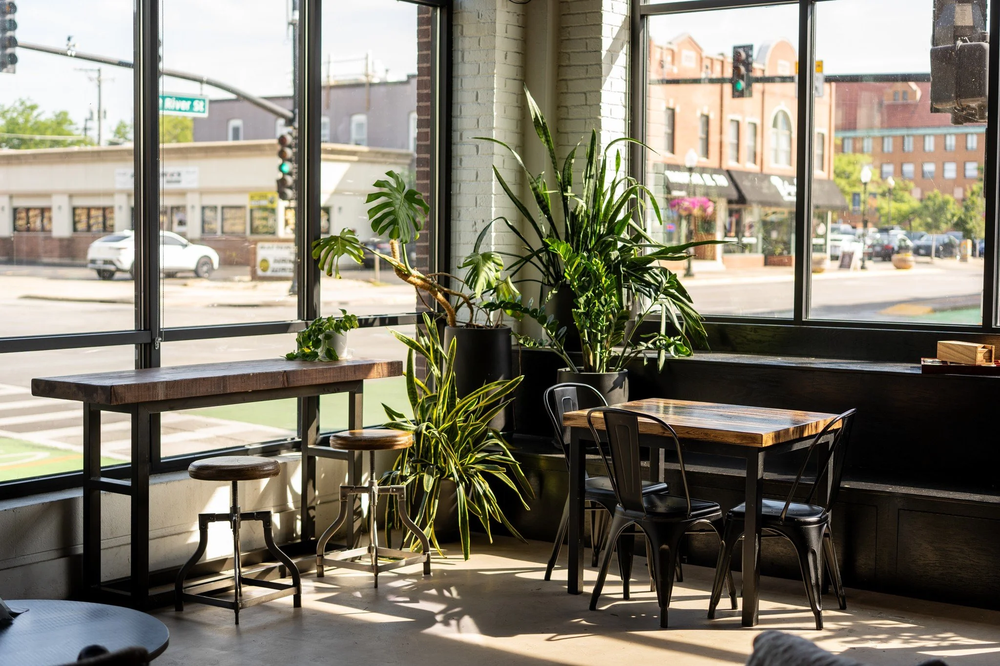 Our caf&eacute; was designed with more than just coffee in mind&mdash;it&rsquo;s a place to slow down, settle in, and feel at ease. Soft, natural light fills the space, complemented by greenery that brings a quiet warmth. Cozy corners invite conversa