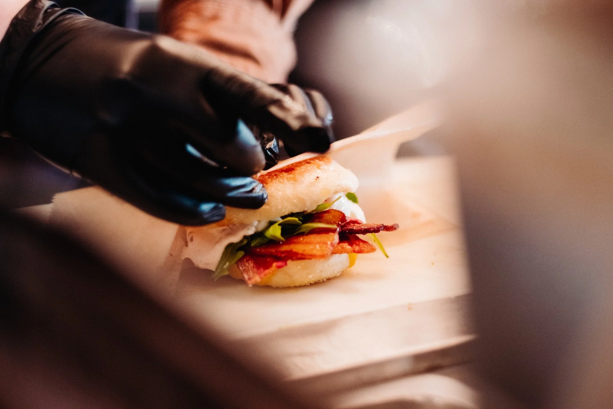 The best mornings start here: toasted English muffin, melty cheddar, crispy bacon, fresh arugula, tangy pickled onions, a soft poached egg, and sambal aioli for just the right kick. This isn&rsquo;t just breakfast &mdash; it&rsquo;s your new ritual.
