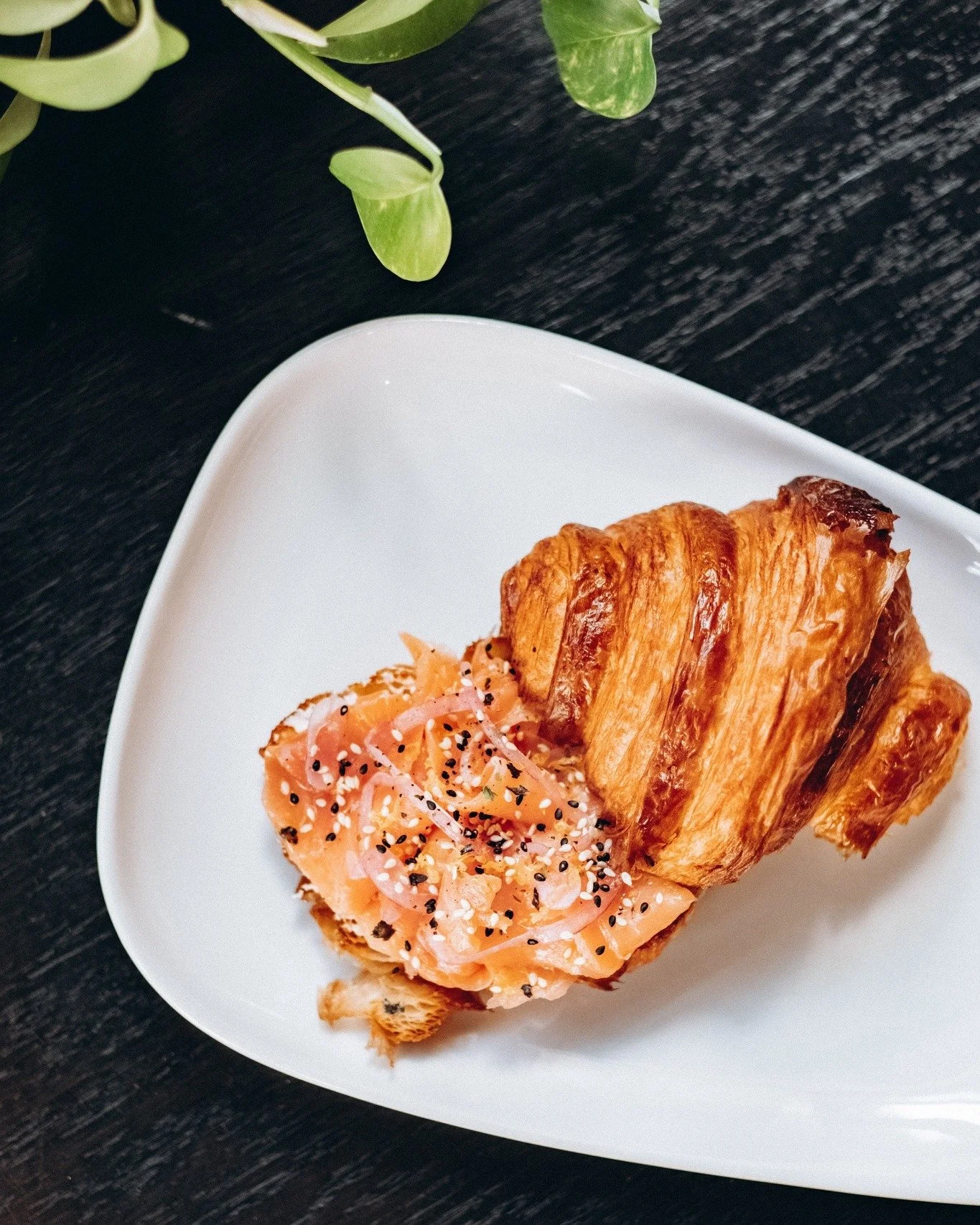 Flakey butter croissant, goat cheese, and smoked salmon with all the flavor&mdash;lemon, fresh zest, olive oil, dill, sliced onion, furikake. It all comes together perfectly in our smoked salmon croissant. Made fresh and to order. Perfect for an earl