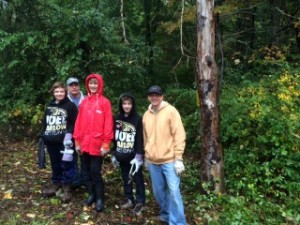 Scouts from Troop 15 clear invasive plants from the Dan Beard property