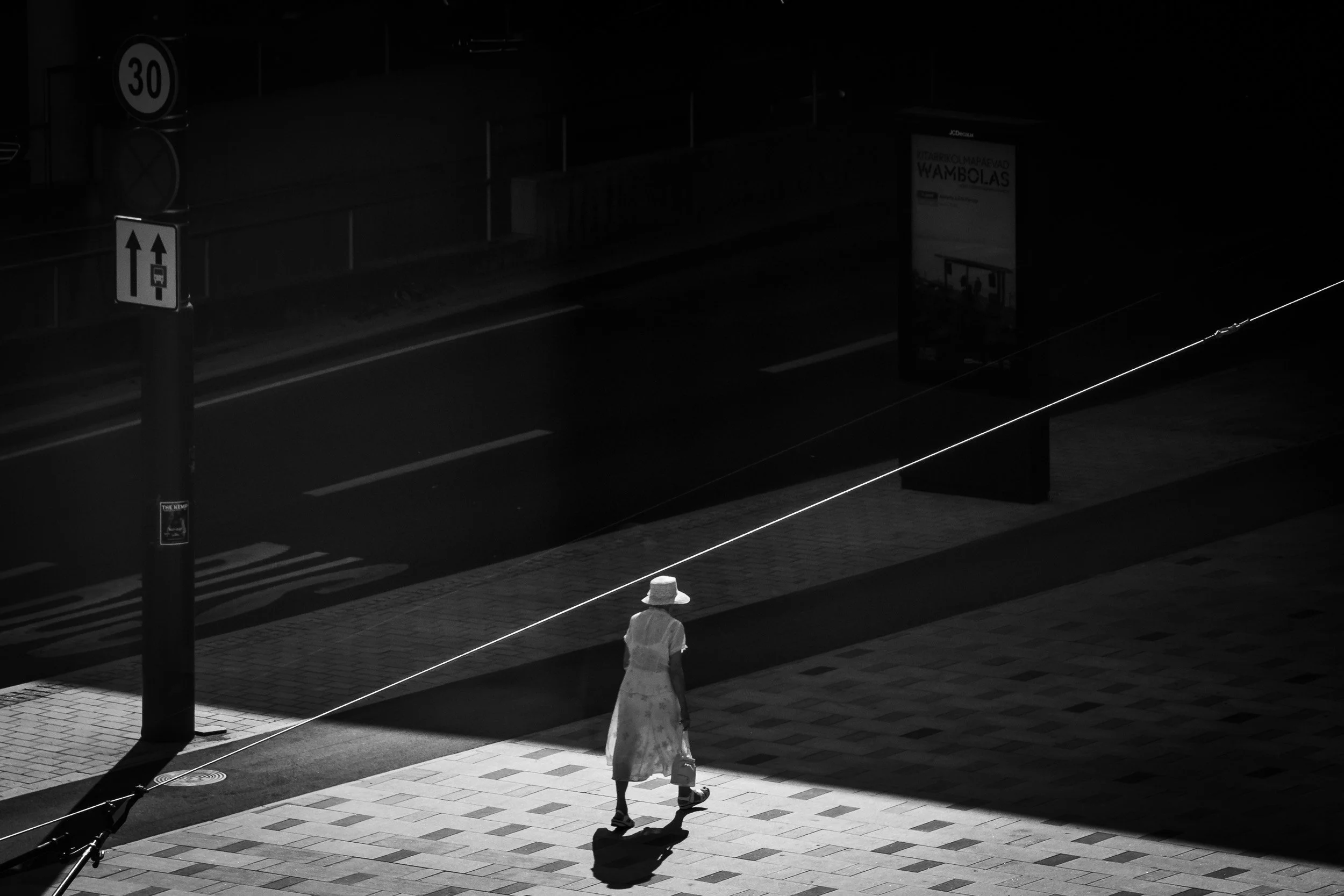 2025-14-woman-walking-from-light-to-shadow-merja-varkemaa.jpg