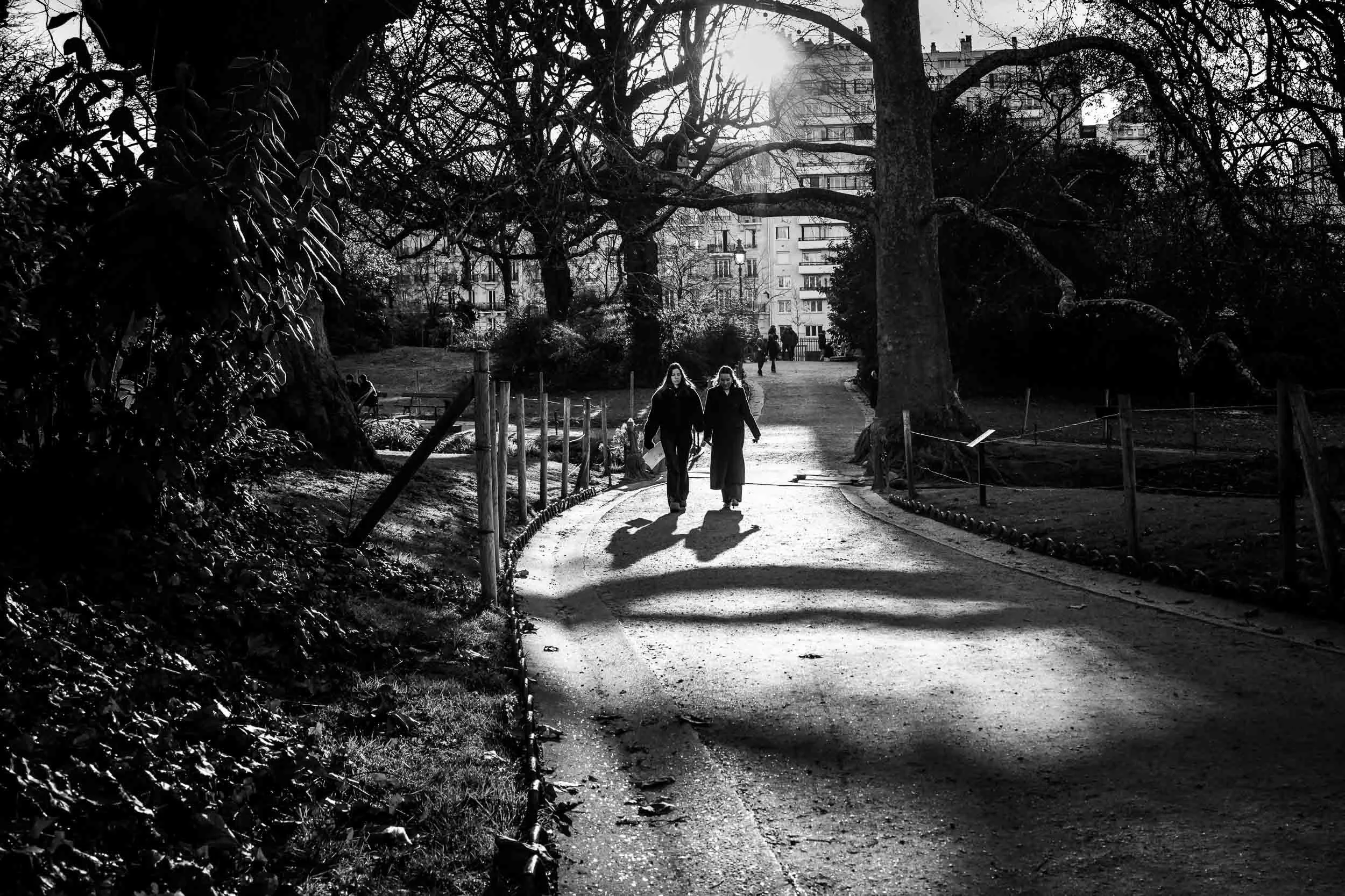 1-two-women-walking-in-park-contrasted light-black and white-merja varkemaa photography.jpg