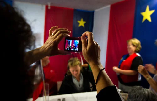 Family members snap photos at a family gathering in Memramcook, NB, on the eve of National Acadian Day.
