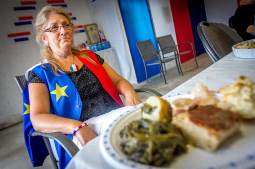 Eveline LeBlanc sits in front of a plate of rappie pie, poutine rapee, chiar, fricot, goose tongue, and pet de soeur at a traditional Acadian dinner they hold for about 30 members of extended family in their garage every August 14. Family travels from as far as British Columbia to take part in the tradition.
