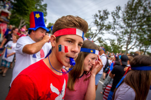 A participant in the 2016 Tintamarre in Caraquet blows a whistle as the crowd attempts to make as much noise as possible.
