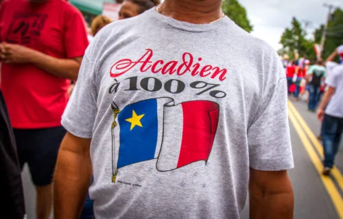 A man shows off his Acadian heritage during the Tintamarre in Caraquet, NB.