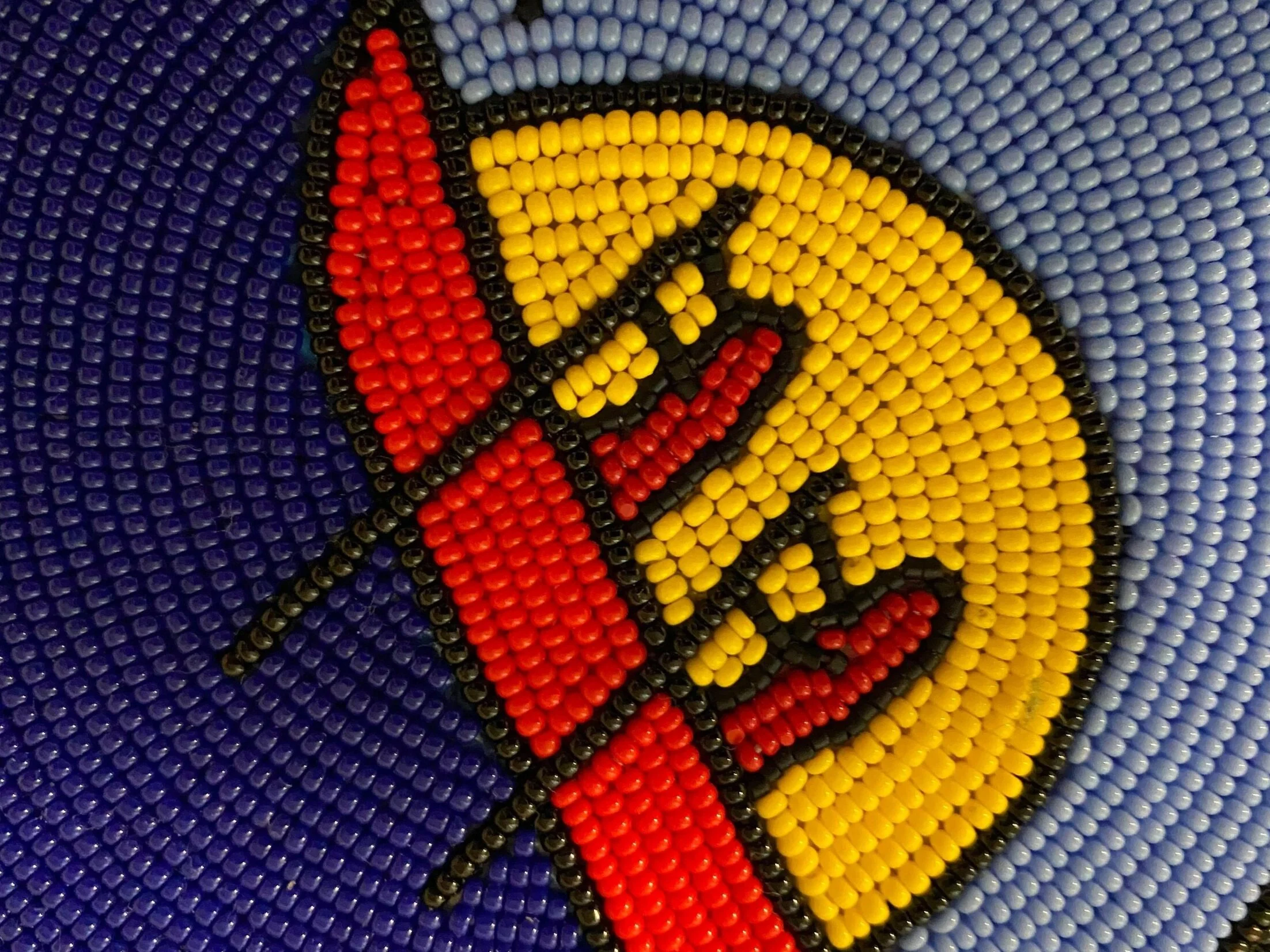 Up-close beading of the Wolastoq Flag. Photo by Alexa Metallic.