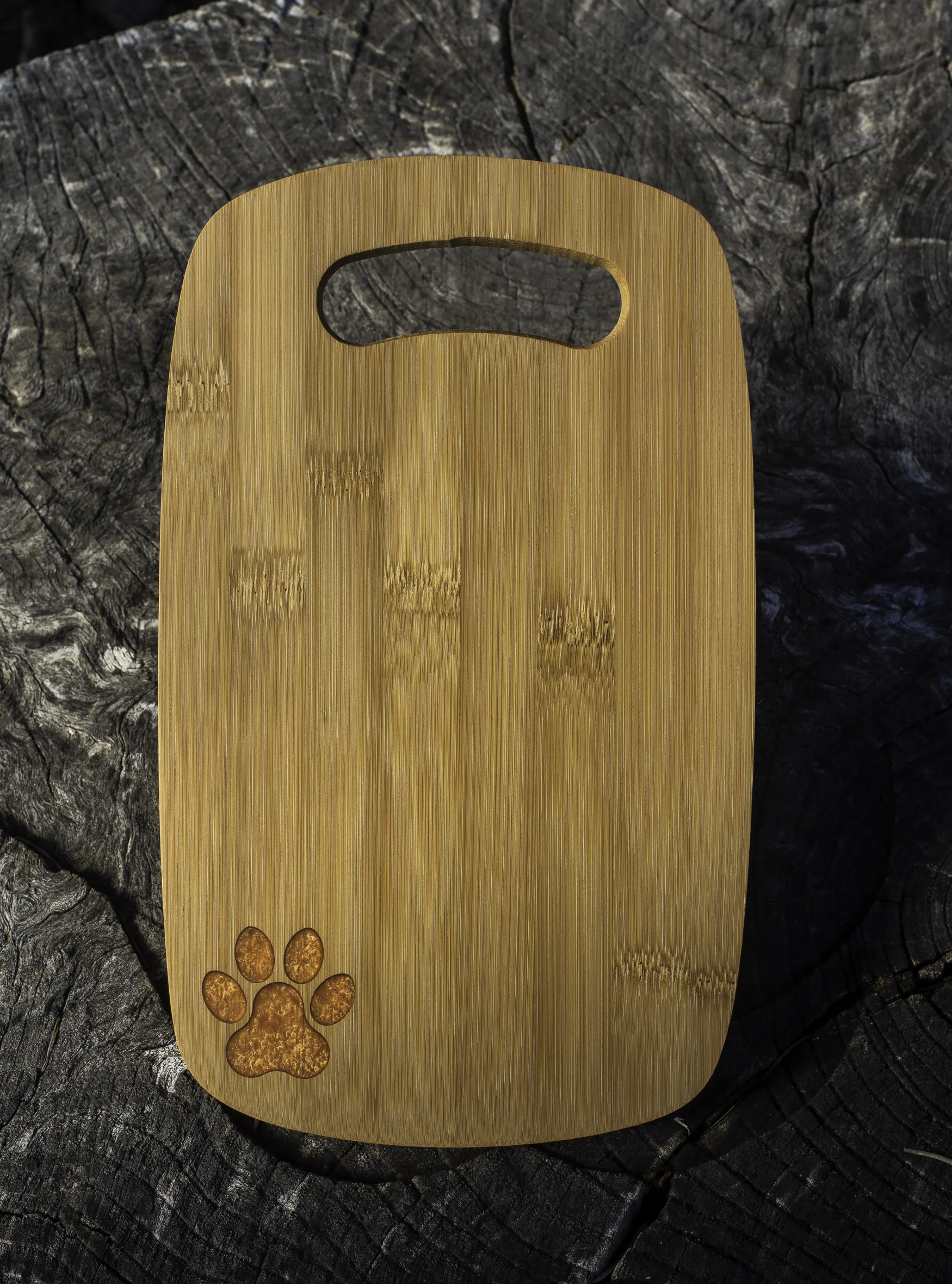 custom laser engraved paw print orange epoxy filled bamboo charcuterie board