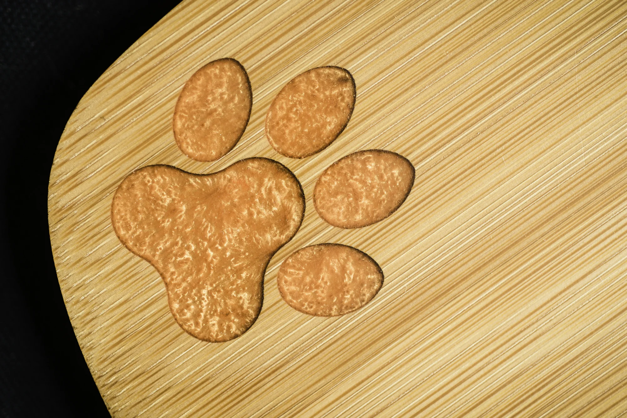 custom laser engraved paw print orange epoxy filled bamboo charcuterie board