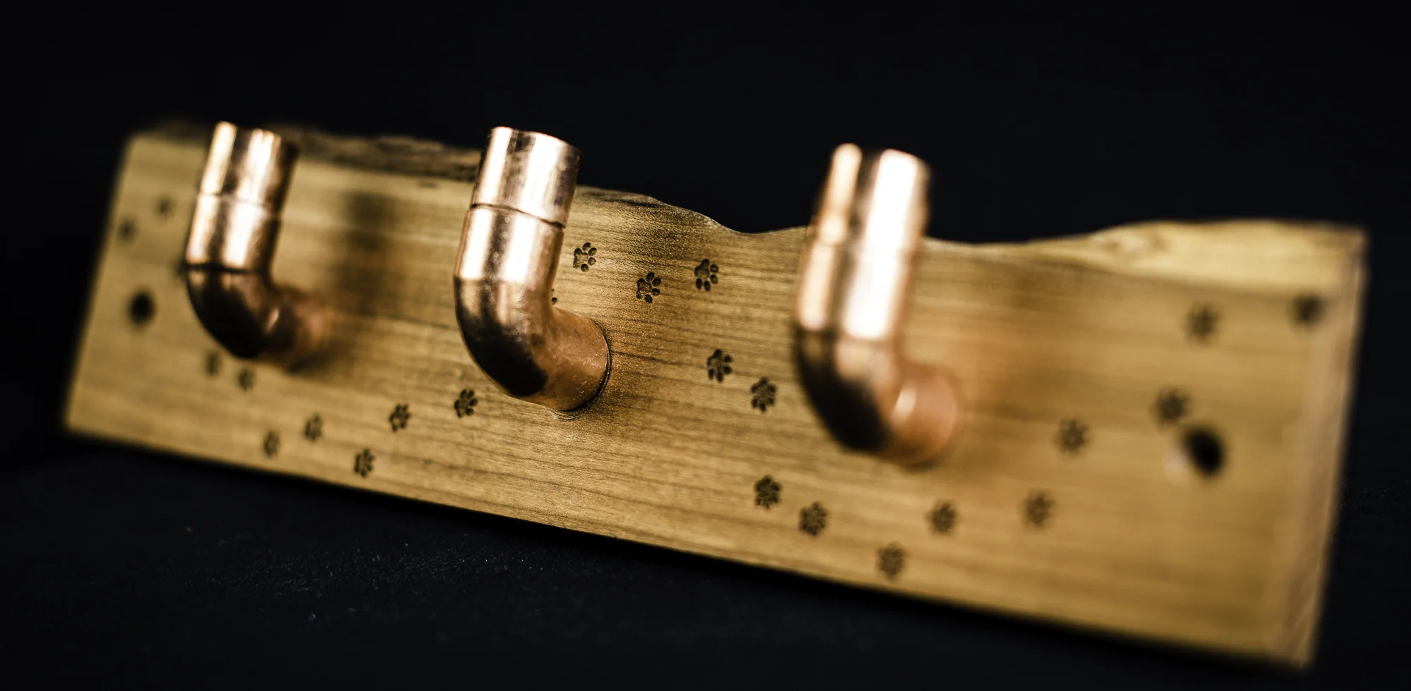 Three copper hooks on paw print laser engraved cherry