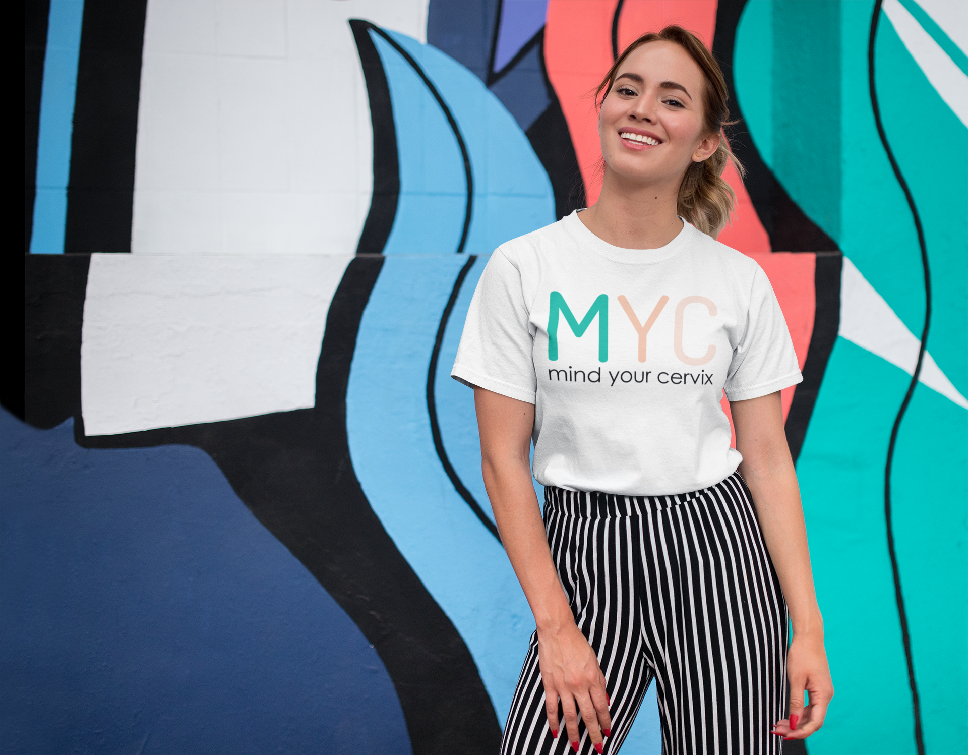 tee-mockup-of-a-smiling-girl-in-front-of-a-wall-with-colorful-illustrations-26646.png