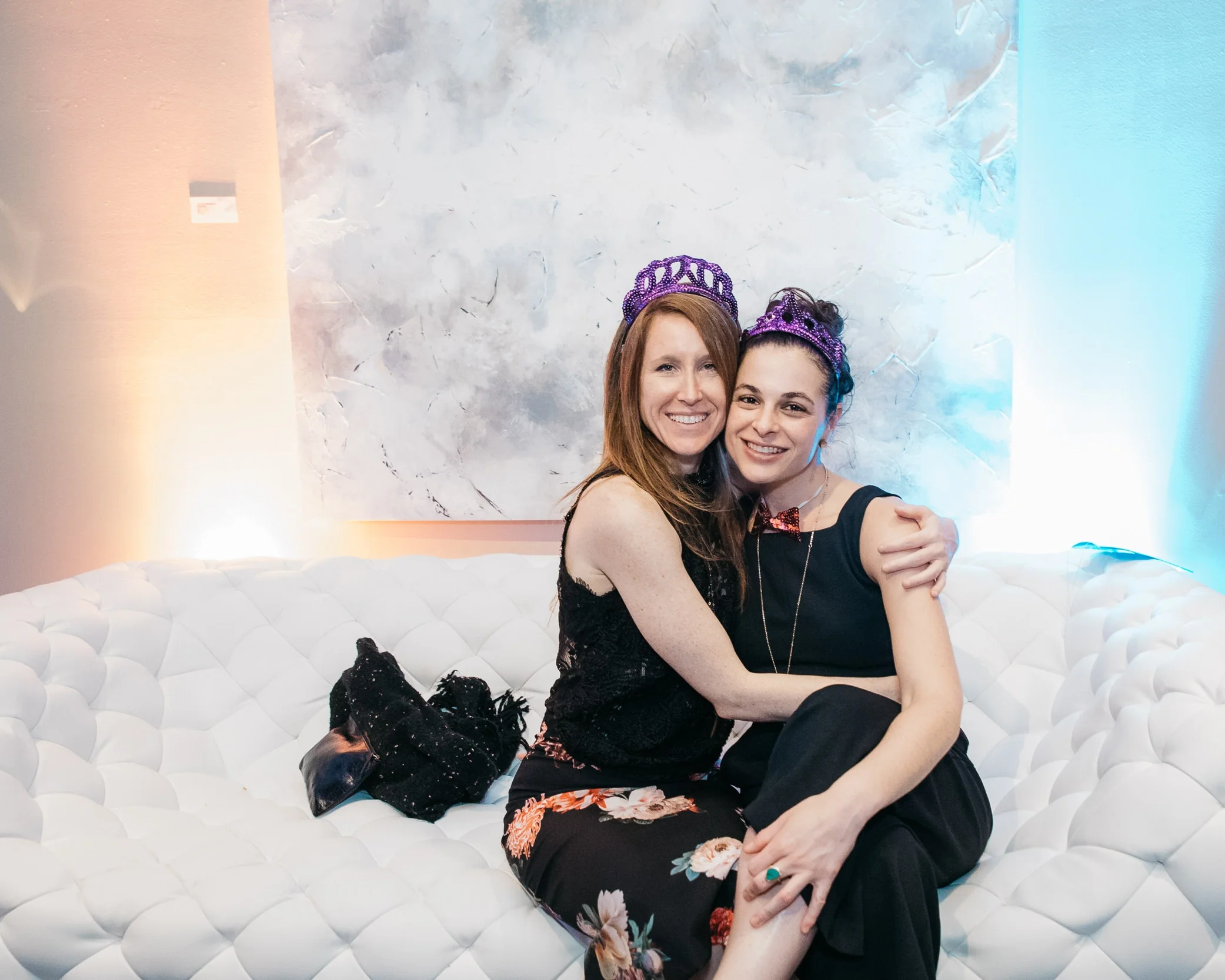 Friends enjoying the beautiful decor at an art gallery by Lor Photo
