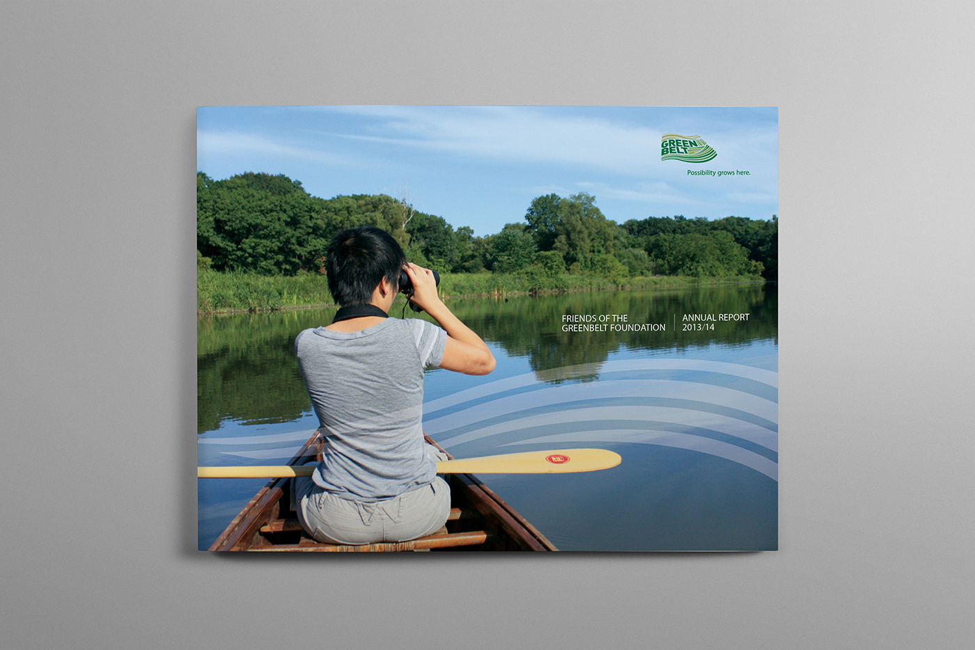 Woman canoeing and taking photos in lake in Canada’s Greenbelt.