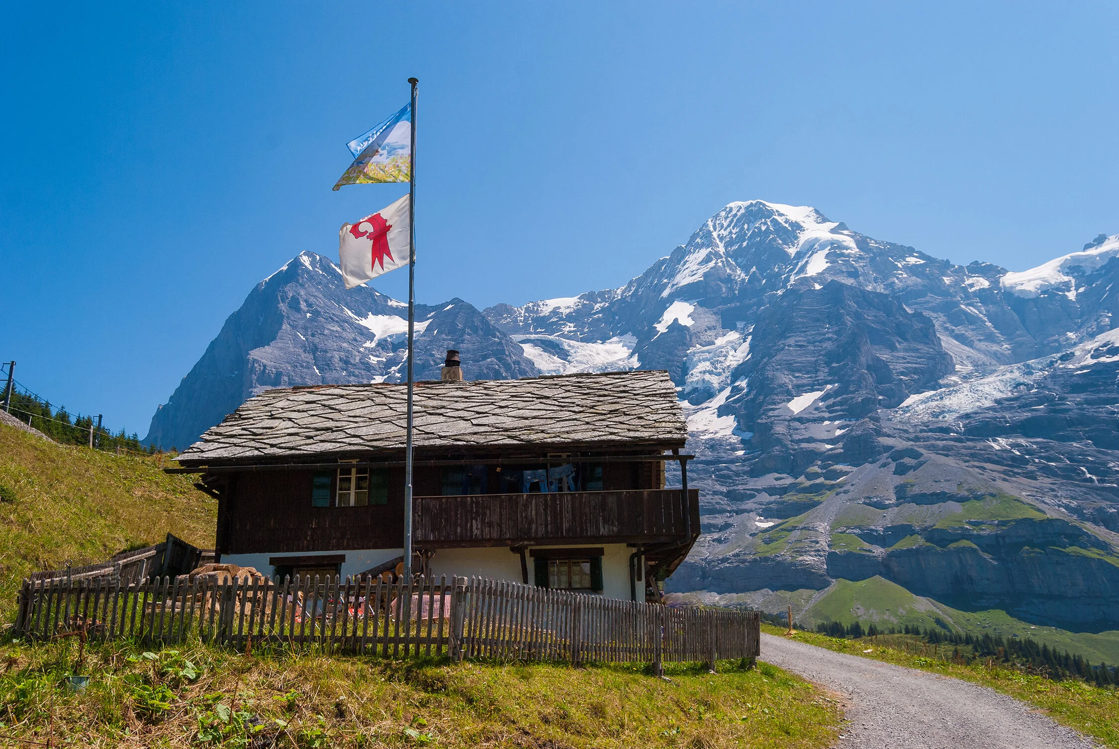 A Swiss chalet at Wengernalp with the Eiger and Mönch in the background—Berner Oberland.