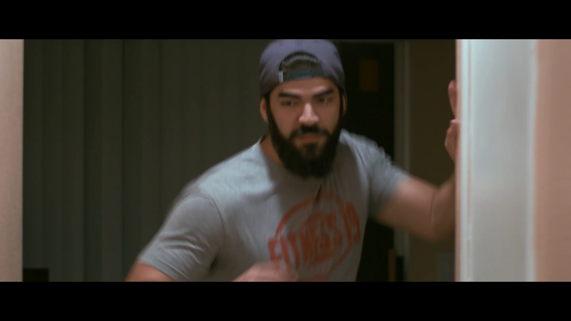 Michael Cards running down a hallway as the character Dom from the first trailer test screening.