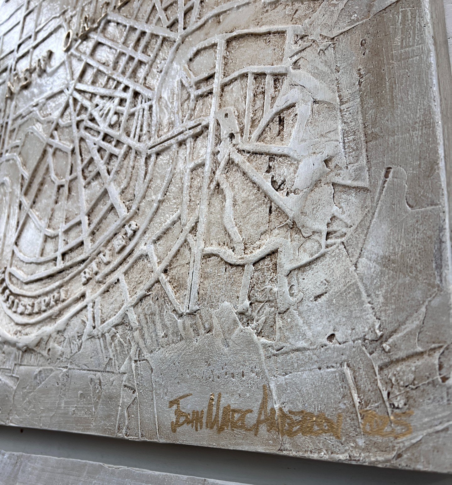 Closeup of City Of New Orleans relief map showing raised detail of streets and waterways. Measures 24"x30", signed in gold by John Marc Anderson
