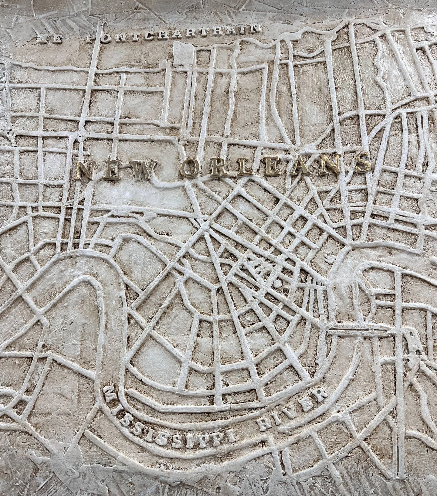 Closeup of City Of New Orleans relief map showing raised detail of streets and waterways. Measures 24"x30", signed in gold by John Marc Anderson