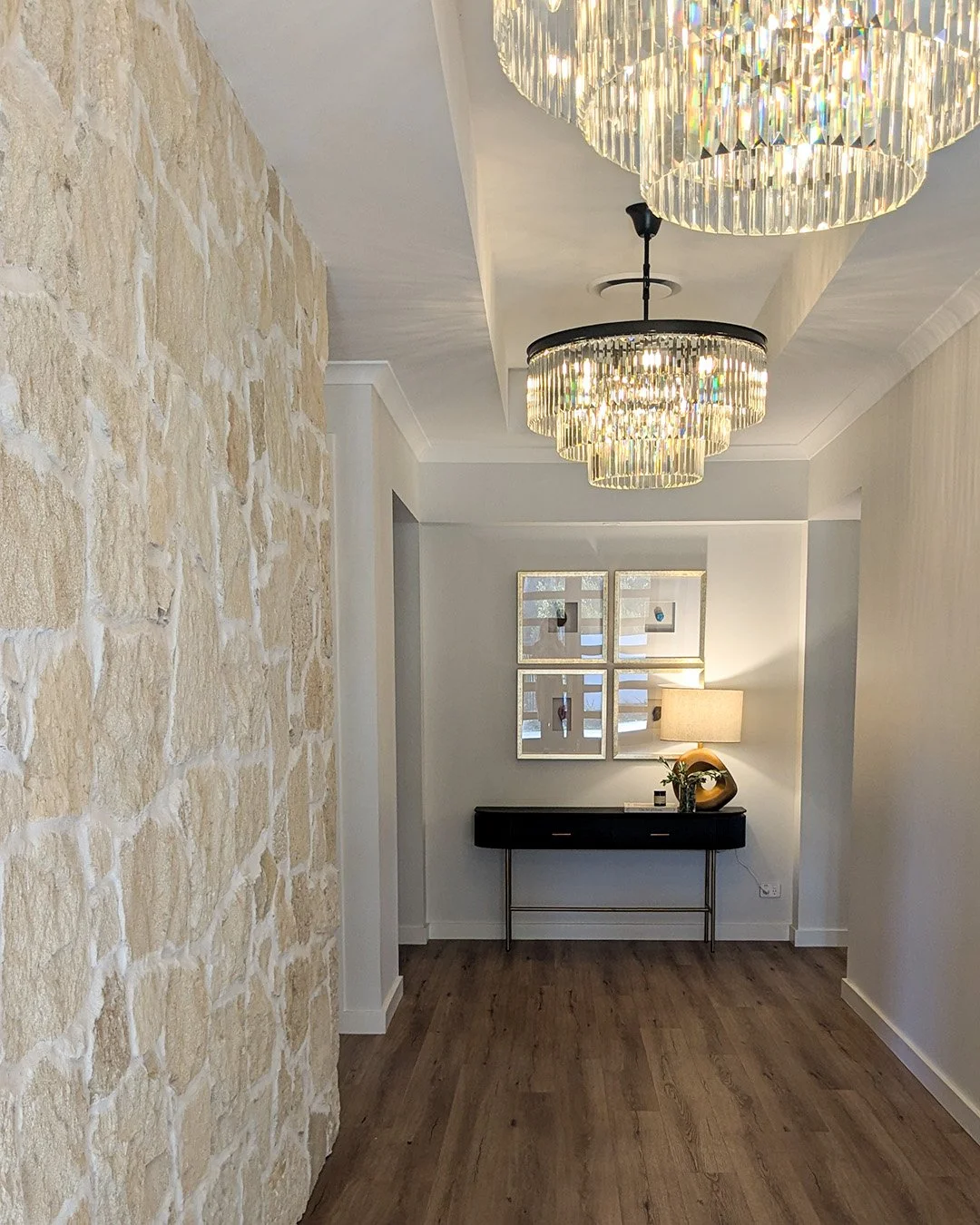 Entry way with chandeliers and hall table and art