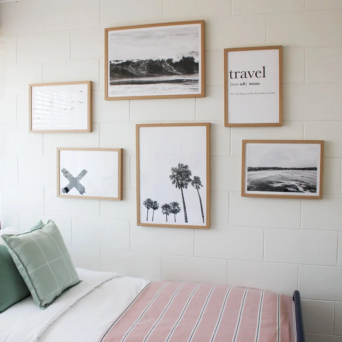 In this Glenelg Airbnb, I kept the artwork black and white and framed it all in oak to keep things calm and consistent.
⁠
Because in a smaller room, it&rsquo;s all about balance and I wanted the bed linen to pick up the colour in the space. 

Overall