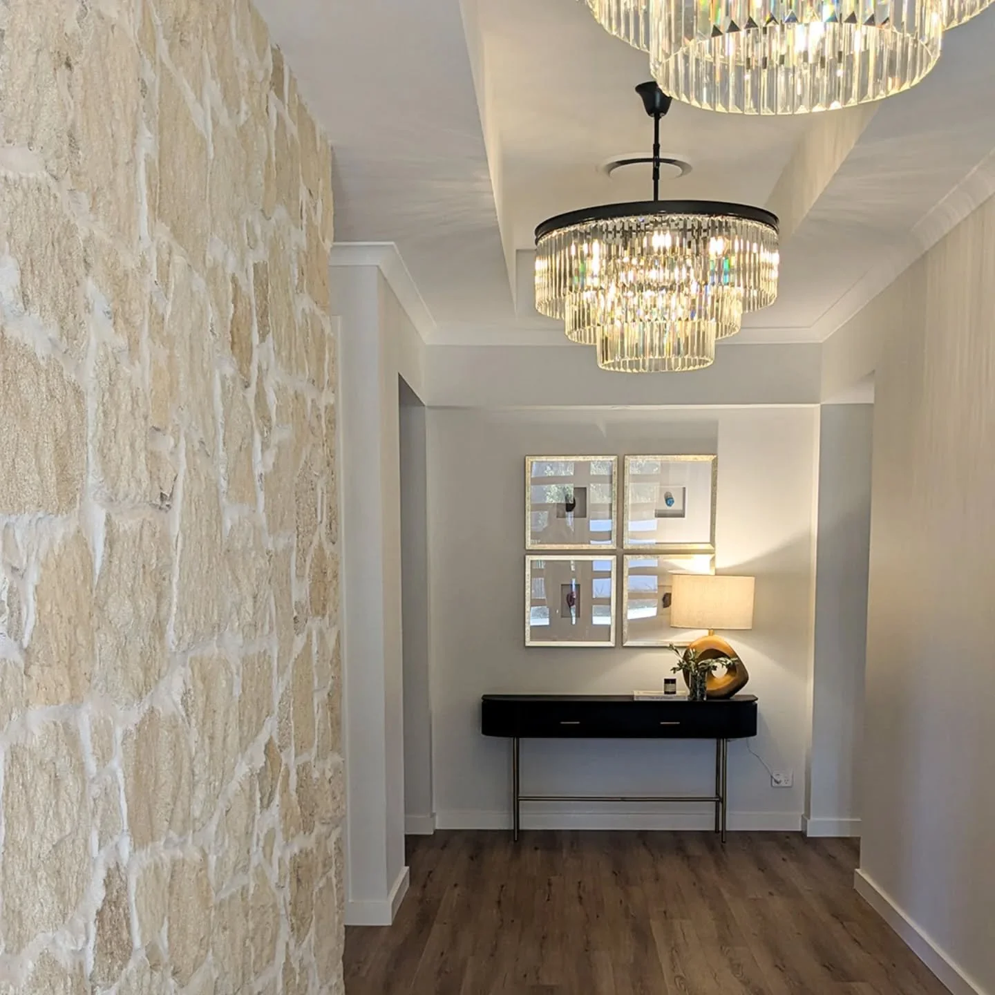 This entry hallway in Mount Barker was all about creating a beautiful feel, and lighting played a big role in bringing it to life.⁠
⁠
I used a mix of statement chandeliers for visual impact, plus softer ambient lighting for the console table to creat