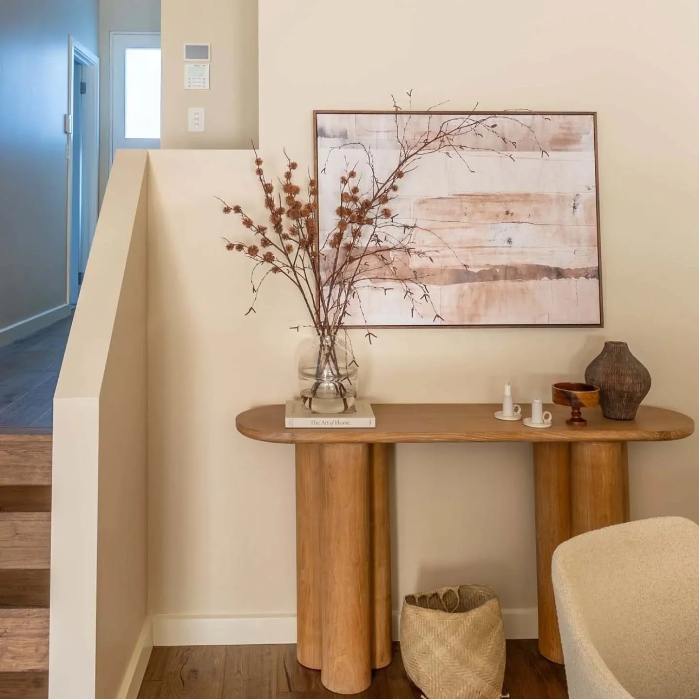 In this space I worked with my client to create a modern Japandi style home. ⁠
⁠
For this dining area nook we introduced a warm neutral paint colour, alongside a curved hall table with a dusky pink artwork that you see as soon as you enter the home. 