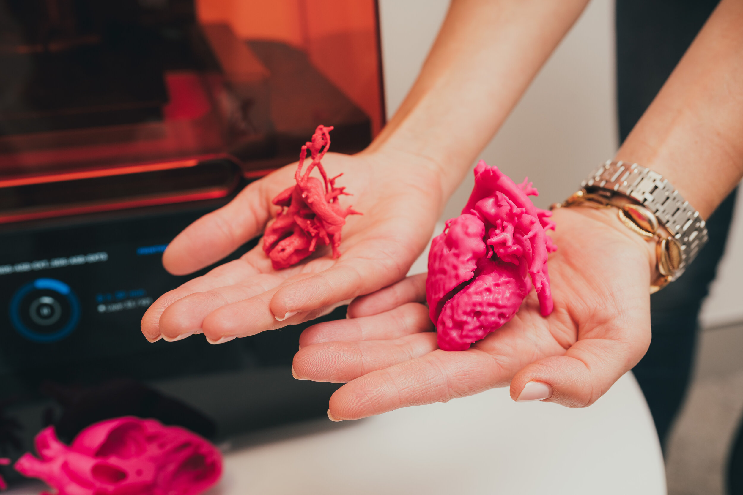 3d printed hearts held in adult palm