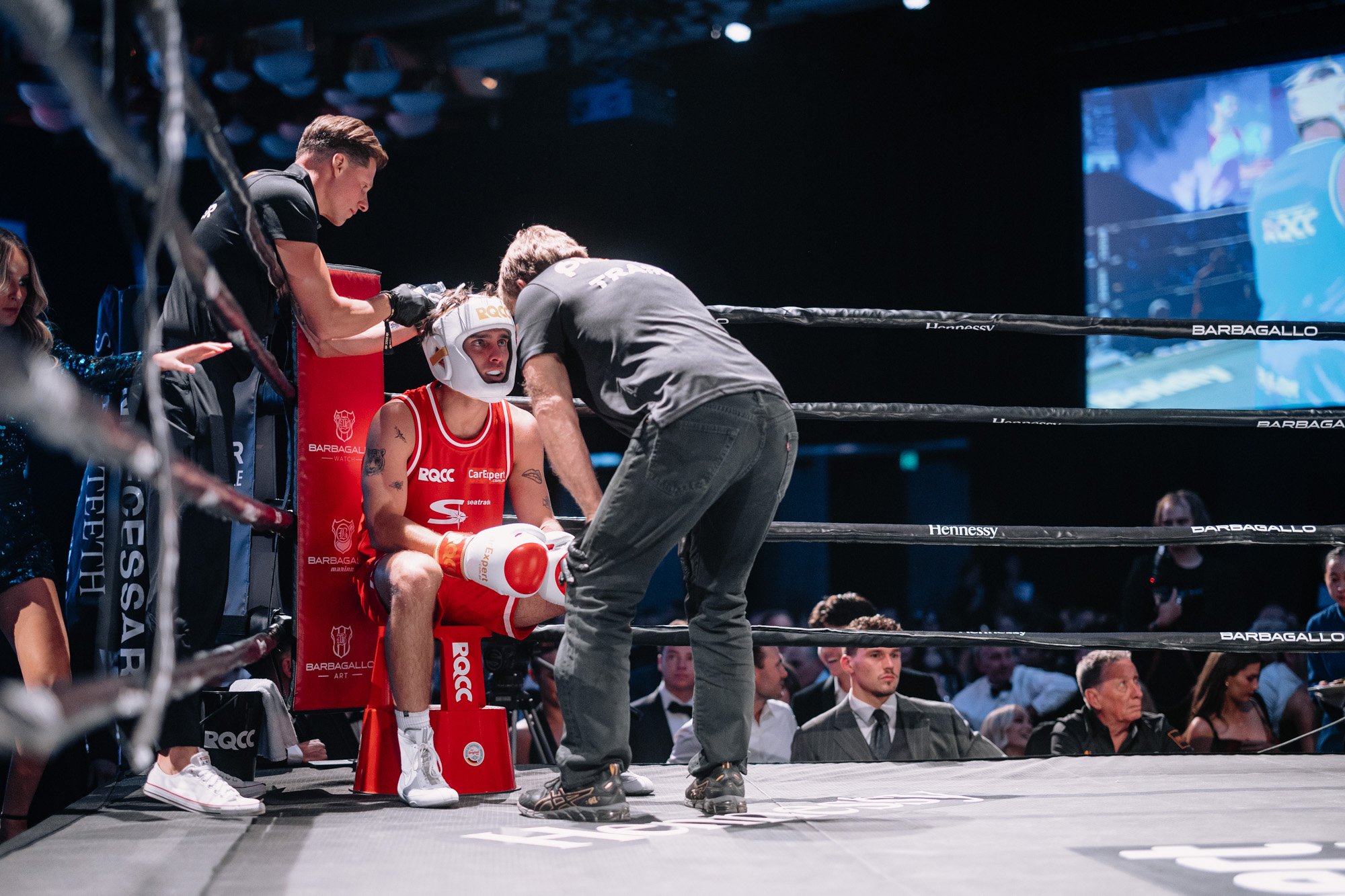 a boxer in the ring corner with coaches