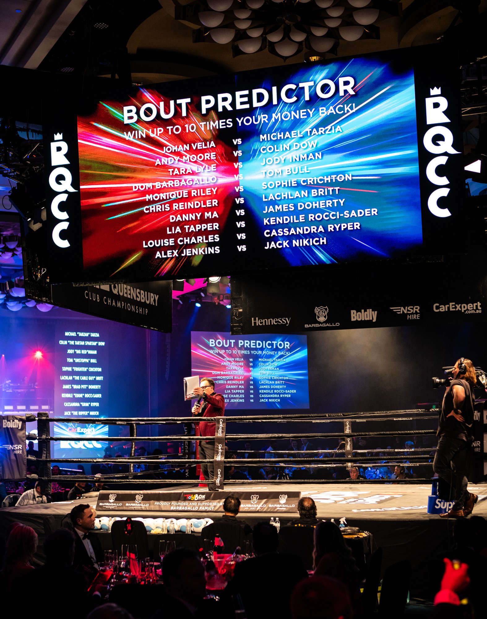 boxing ring with large screens showing bouts