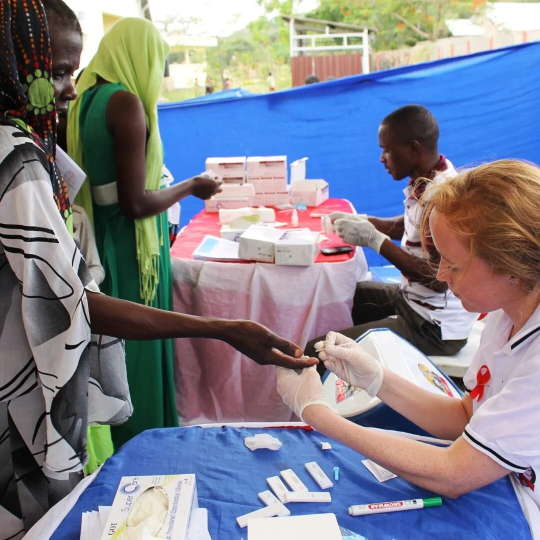 Volunteer healthcare worker supporting community health outreach services in Tanzania