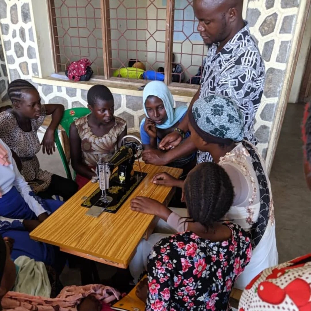 Women learning vocational and entrepreneurship skills through community training in rural Tanzania