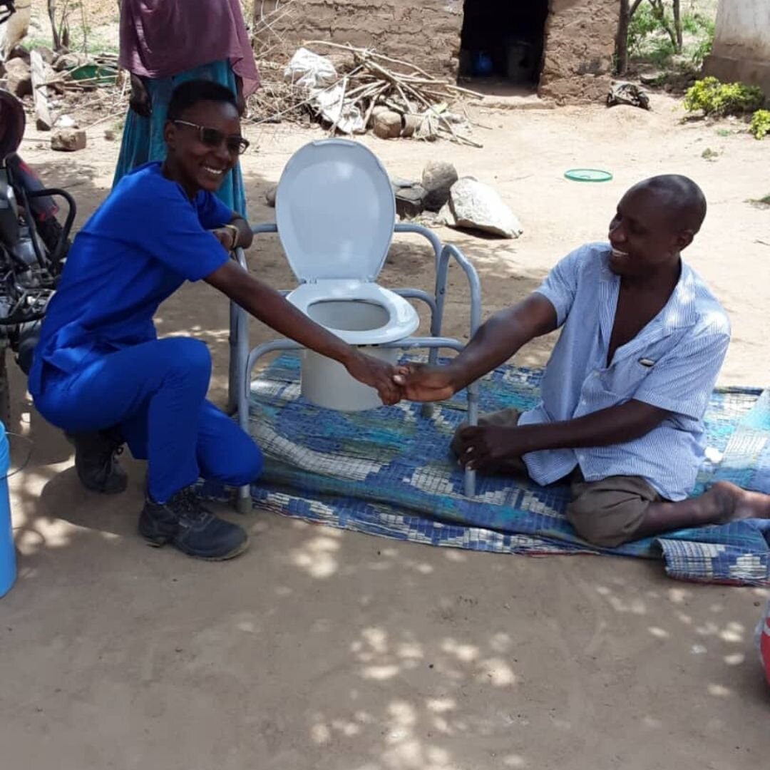 Man with disability receiving mobile toilet from our Outreach Team