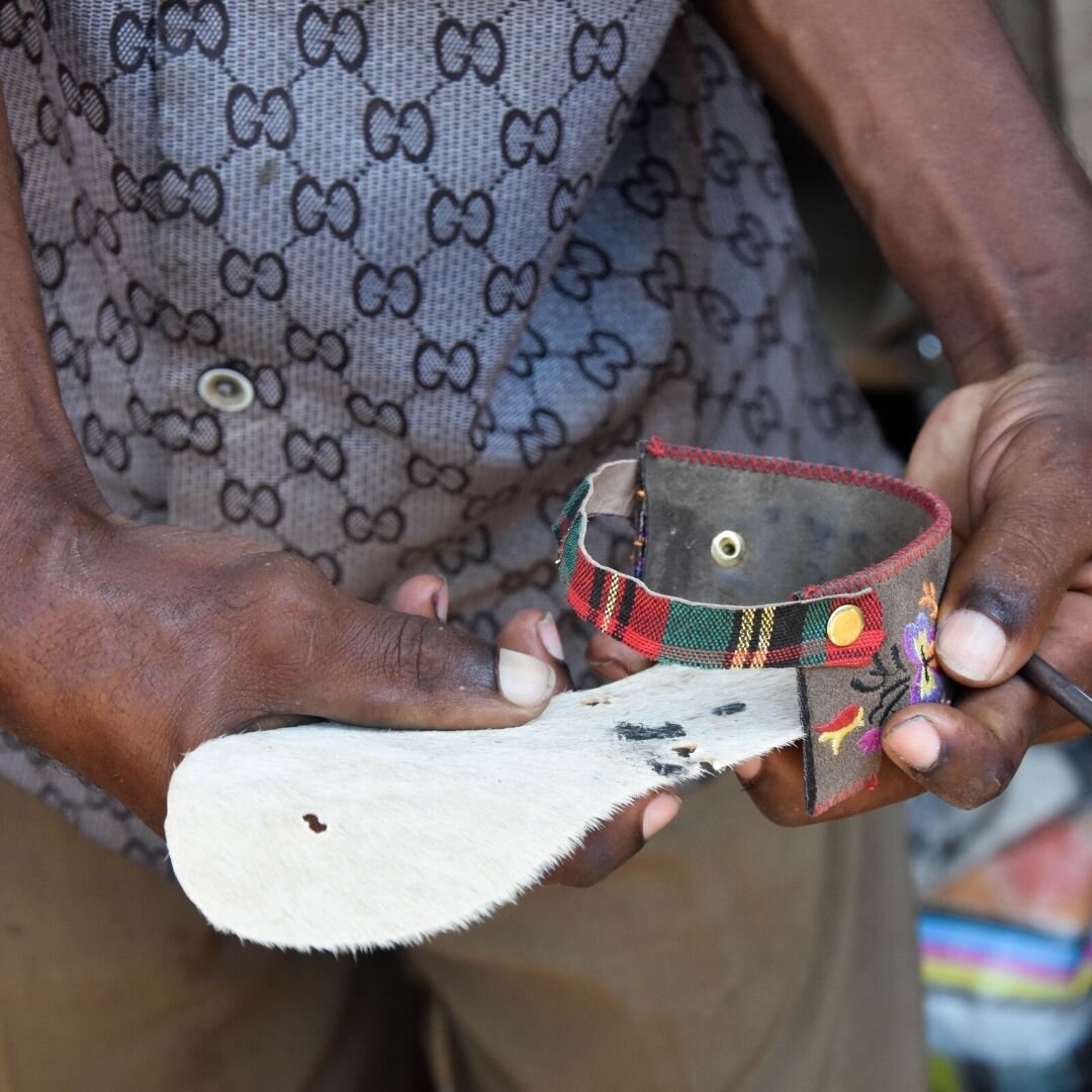 Man with disability making a living producing handmade sandals