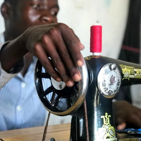 Fred is deaf and has struggled to find work. He is now a tailor.