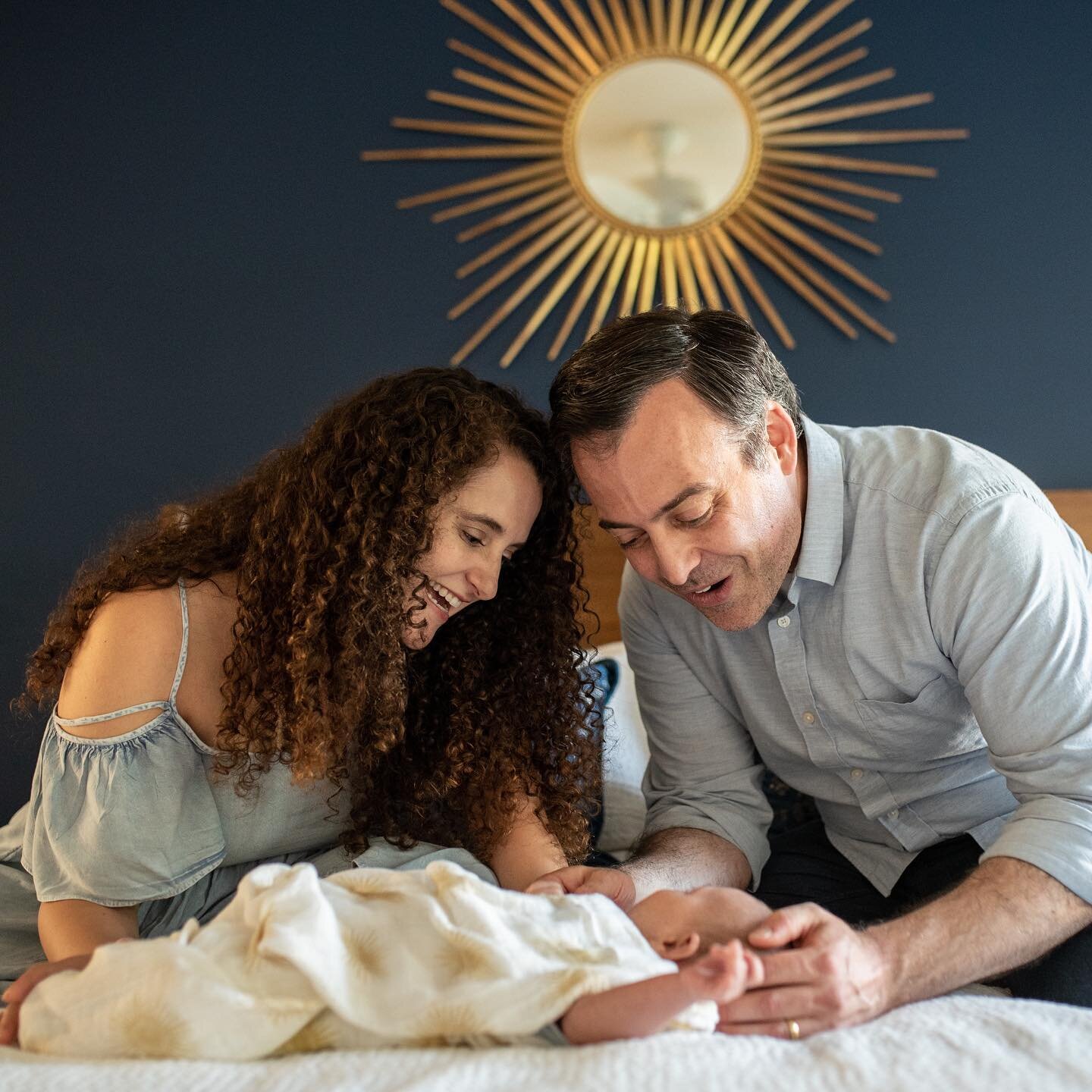 I am just swooning over these photos with Baby Bennett! 😍Can you tell how his parents absolutely adore him? (Also the beautiful dark blue wall and golden sunburst mirror in this room were just perfect&mdash;Angela has such an eye for beauty!) #newbo