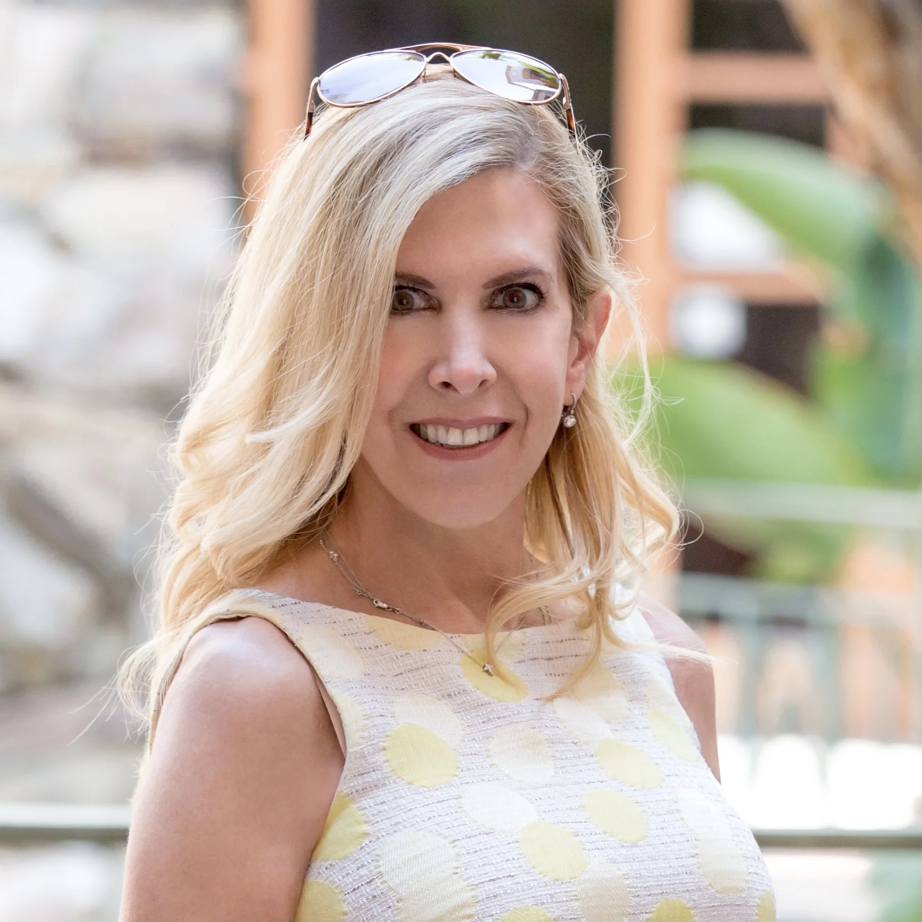 PR firm founder and president Marisa Vallbona, female, standing in Los Angeles courtyard on a sunny day