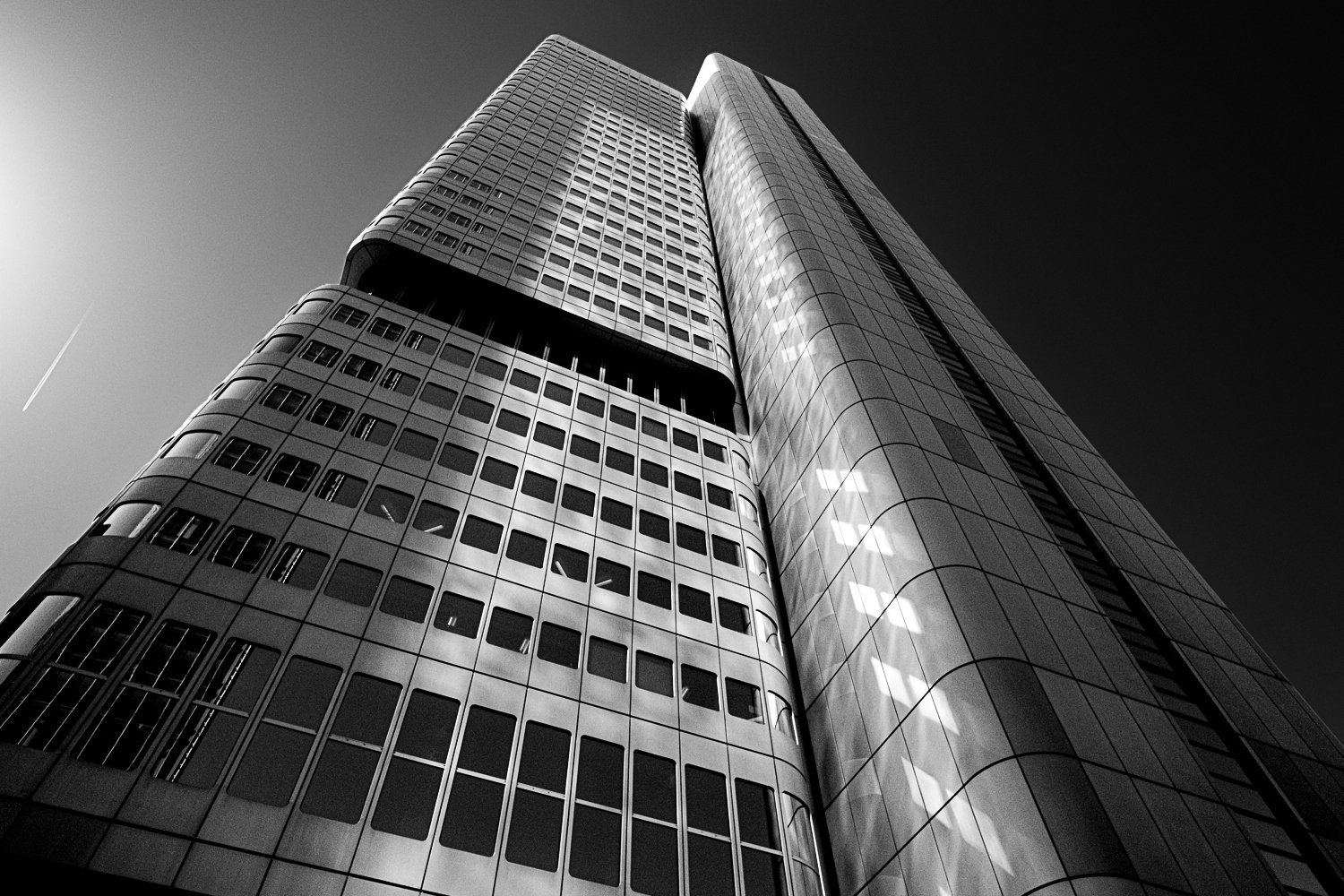 Looking Up — geometric skyscraper architecture against blue sky in Frankfurt