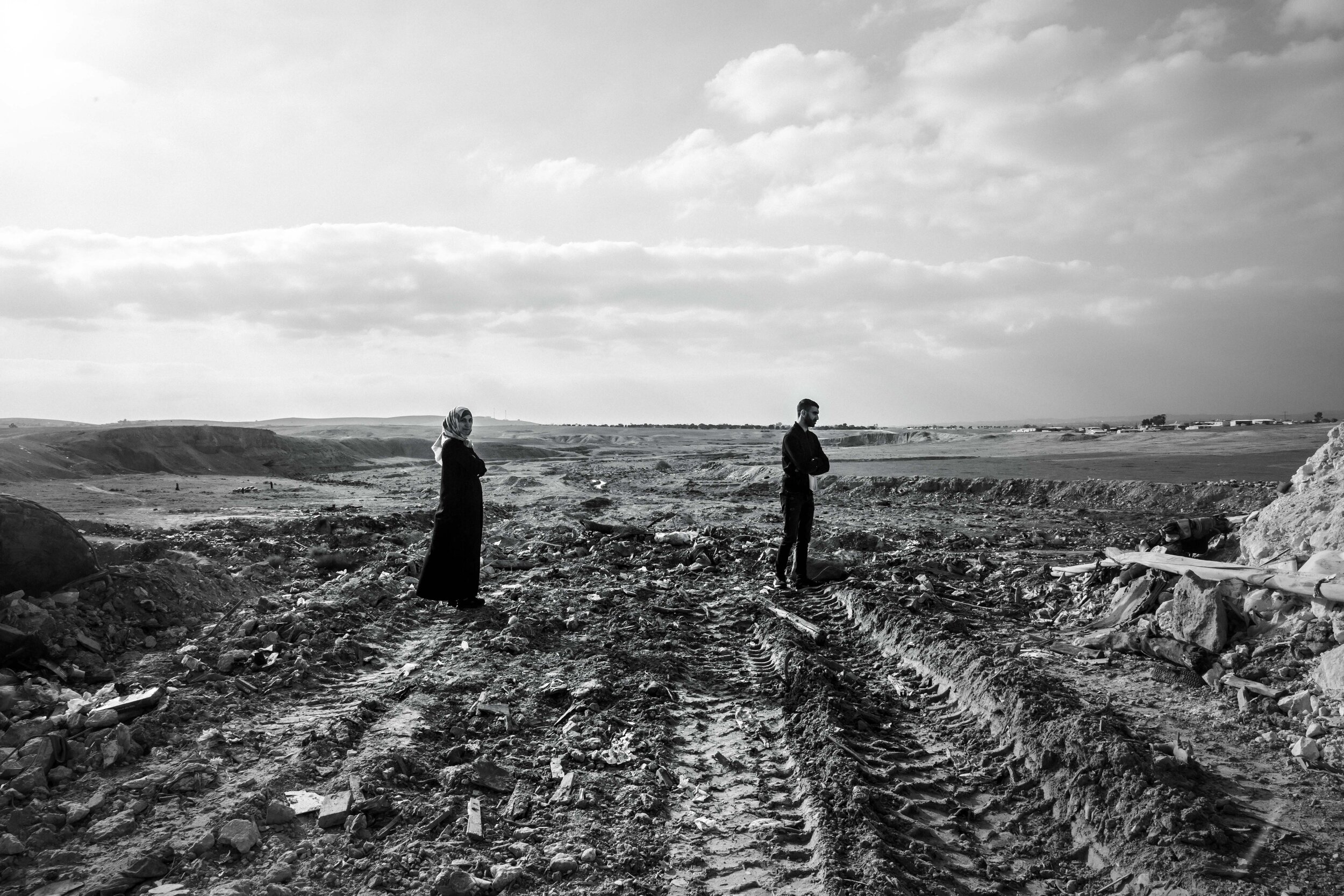 Aya and Sameh, cousins from Azzarnug, looking over a beautiful valley which is partly used as a dumping ground for industrial waste and partly as a pasture land.