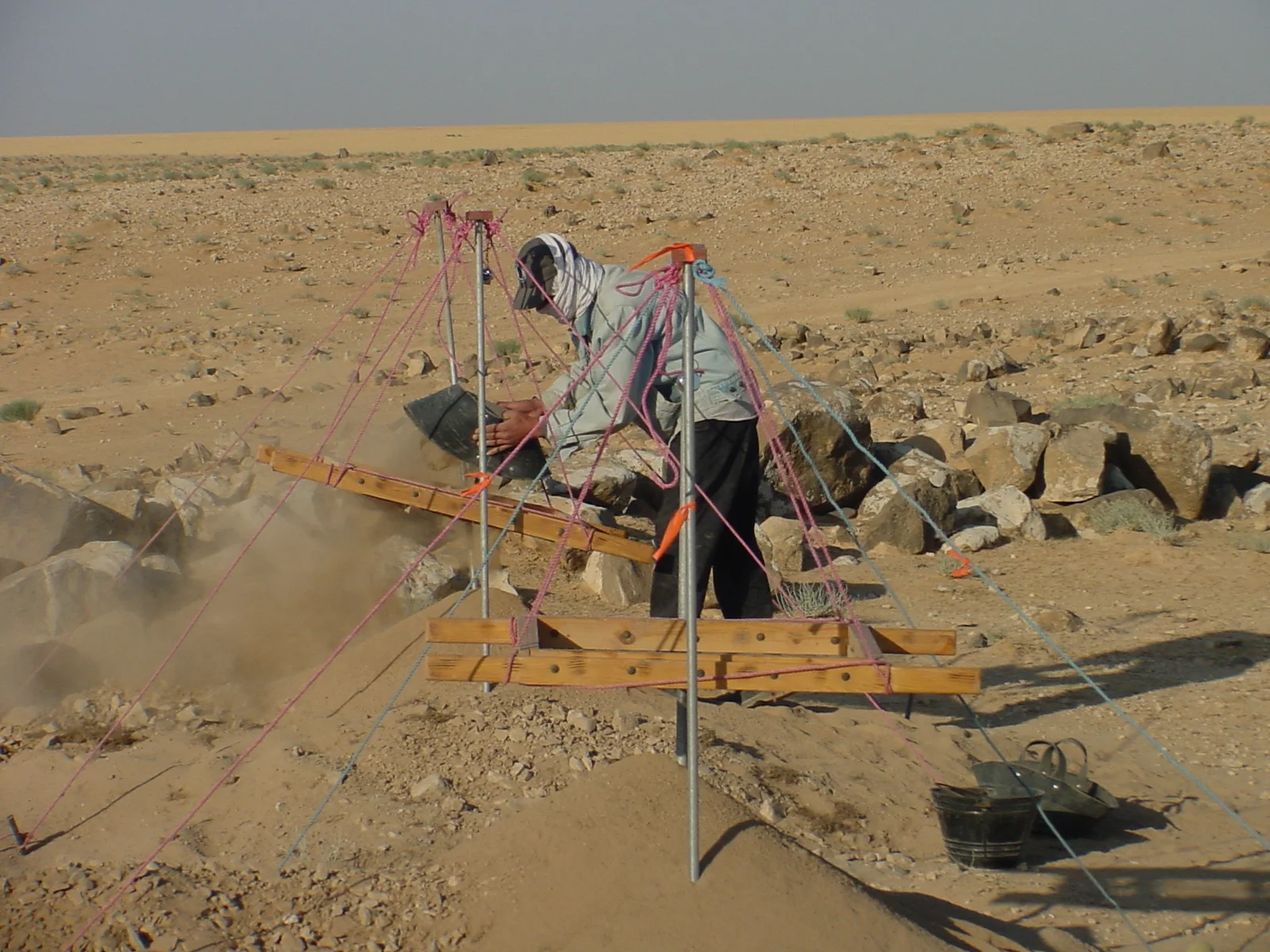   The sherds and soil are then carried to the sift, located a short distance from the square being excavated. The archaeologist who supervises the square keeps a careful record of the location or "locus" in the square where the contents of the guffah