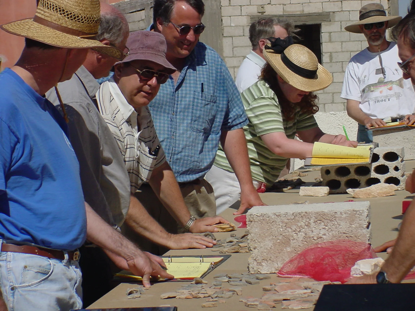   "Reading" is the term given to the initial examination of the pottery, usually by experts with experience in ceramic analysis. It takes place in camp in the afternoon after or during pottery washing. The reading session begins when each square supe