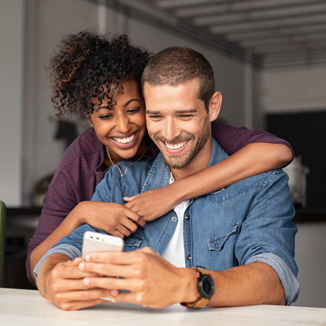 Couple smiling at phone | anxiety counseling in birmingham, al | anxiety counselor in birmingham, al | anxiety counseling in alabama | 35208 | 35209 | 35210