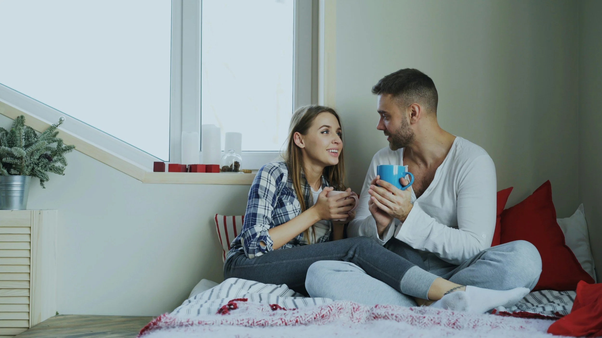 Photo of couple sitting in bed drinking coffee. Wondering if you and your partner can build healthier communication? Learn how couples counseling in Birmingham, AL can help get the support you need for your relationship.