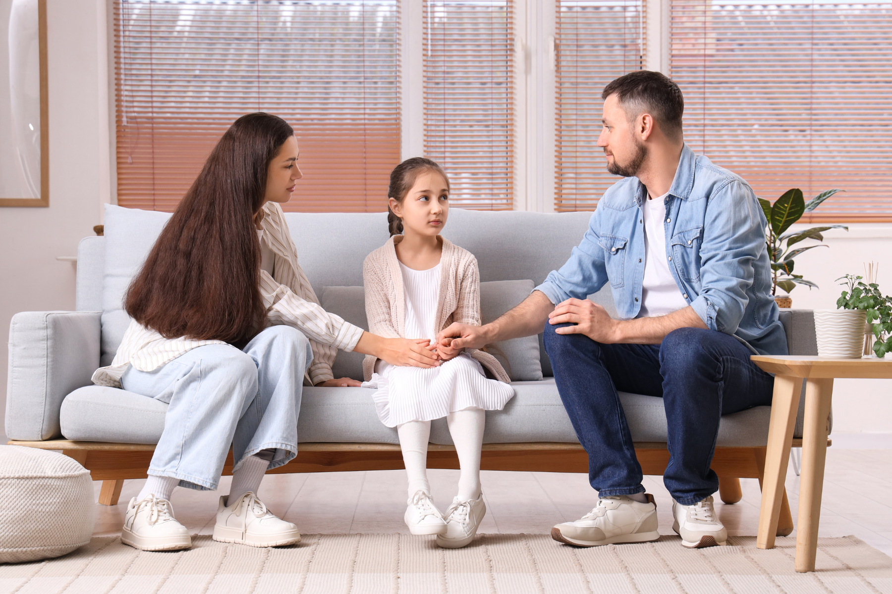 Photo of couple talking to daughter in the middle. Are you struggling to learn how to manage conflict in a healthier way for your kids? Sparrow Counseling in Birmingham, AL is sharing how we support couples and parents in difficult situations.