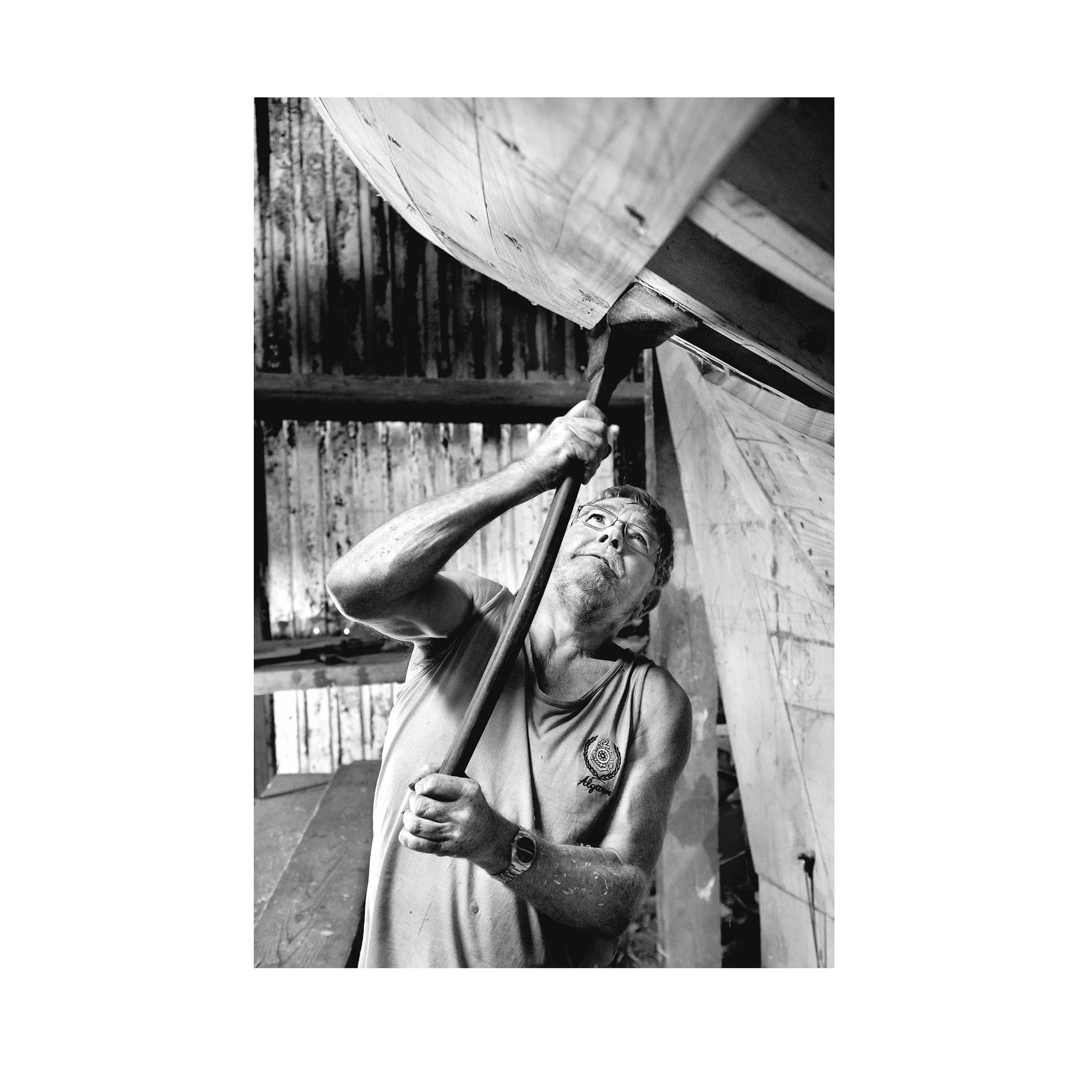 WEB--Hegarty's-Boatyard--Fachtna-O'Suillivan,fairing-frames-with-an-adze-to-ready-them-for-planking.-(2019)-copy.jpg