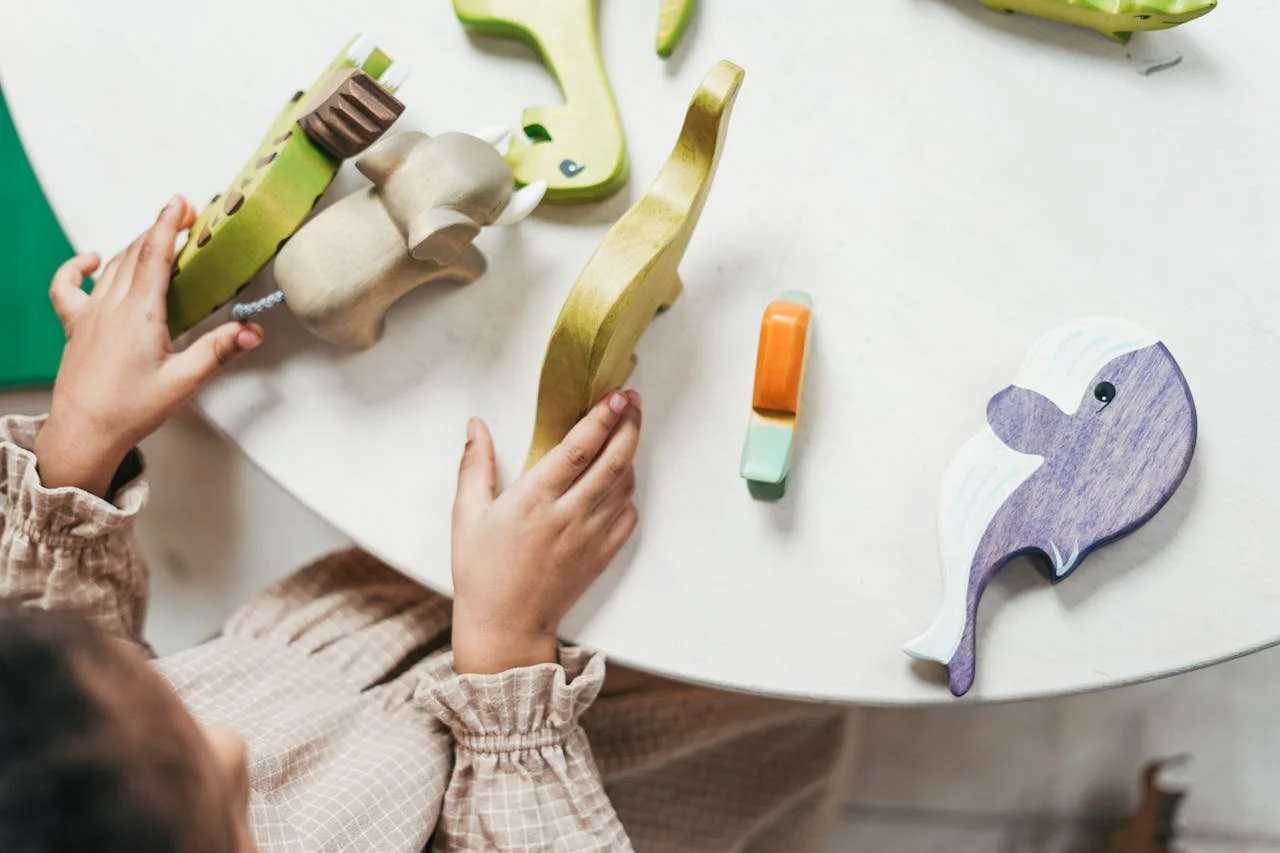 child playing with wooden animals during child therapy in mahtomedi minnesota