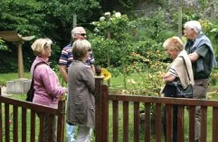 Visitors strolling through a garden at Nunney Open Gardens