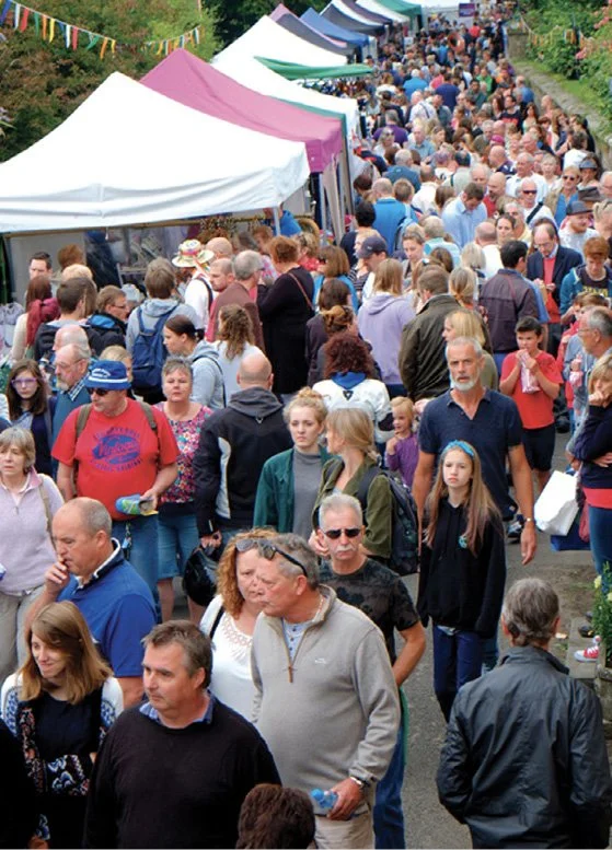 Crowds enjoying stalls in the street at a previous Nunney Fayre