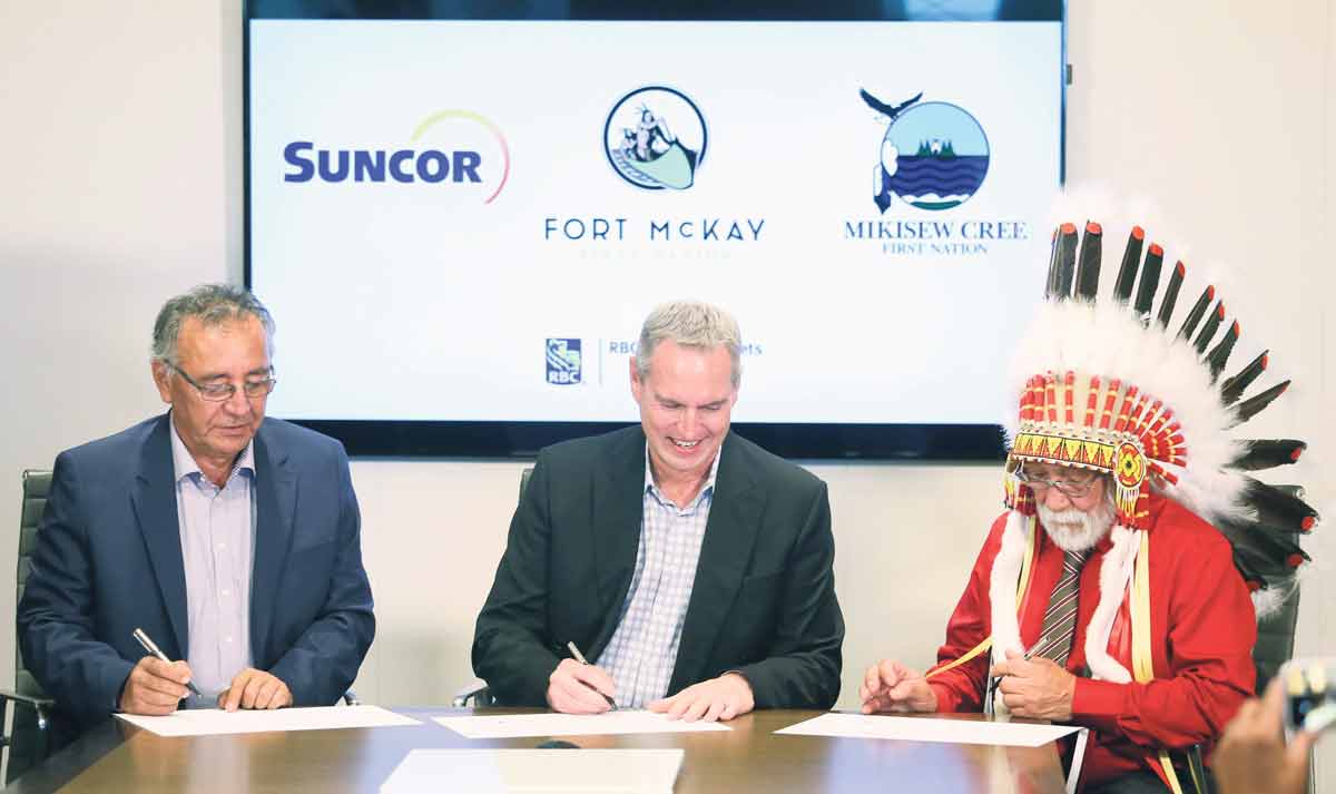 Suncor took a significant step towards working with Aboriginal Peoples to create opportunities for economic and social reconciliation in 2017 when Fort McKay and Mikisew Cree First Nations completed an acquisition of a 49 per cent partnership interest in the company’s East Tank Farm Development. Signing the agreement, from left, are Fort McKay First Nation Chief Jim Boucher, Suncor president and COO Mark Little, and Mikisew Cree First Nation Chief Archie Waquan. SUNCOR ENERGY INC.